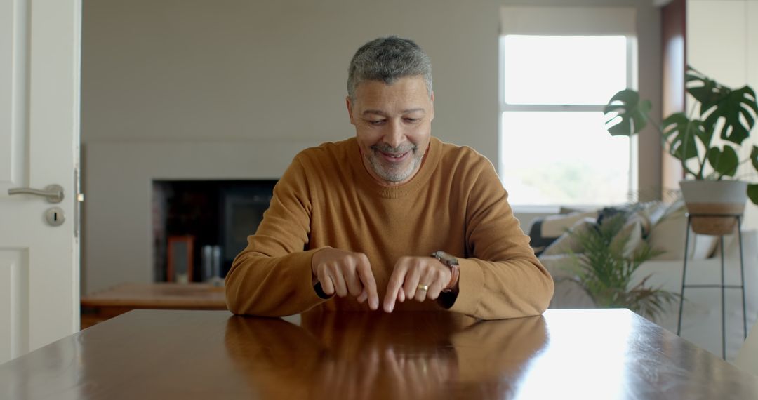 Senior Man Gesturing With Confidence While Speaking at Home