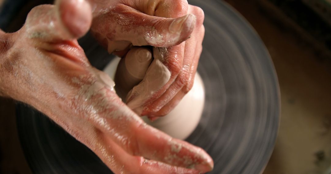 Close-up of hands shaping clay on pottery wheel in workshop - Free Images, Stock Photos and Pictures on Pikwizard.com