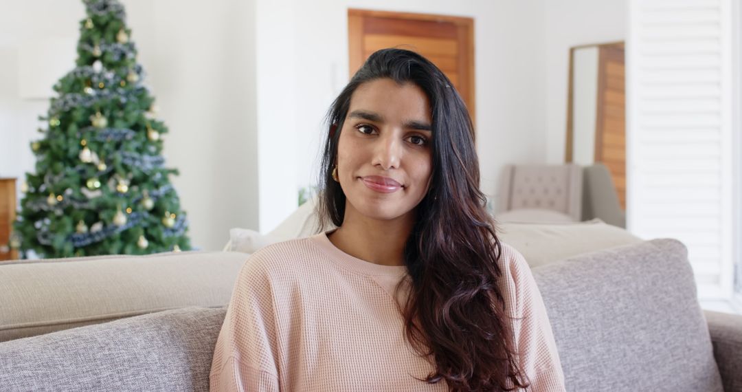 Woman Relaxing on Cozy Sofa in Festive Living Room with Christmas Tree