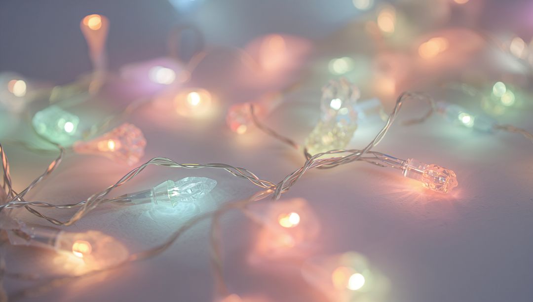 Pastel Faceted LED String Lights Casting Soft Glow and Twinkle on White Surface