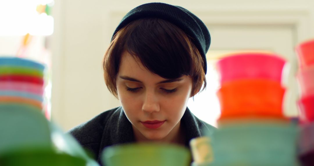 Young Person Browsing Plastic Containers in Store - Free Images, Stock Photos and Pictures on Pikwizard.com