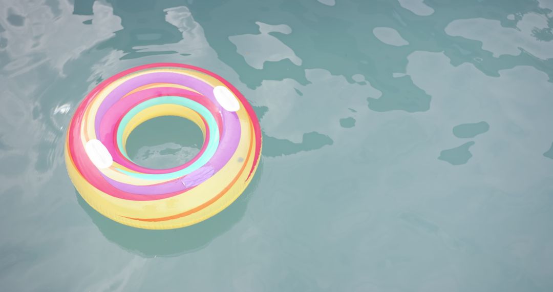 Bright Inflatable Ring Floating on Pool Water