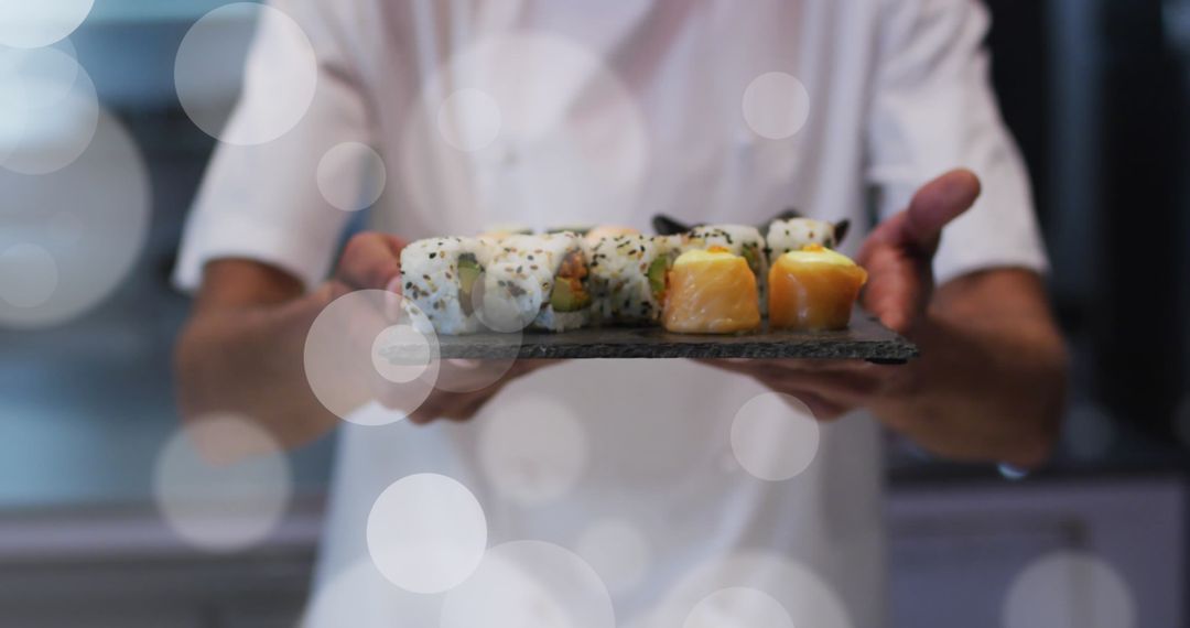 Chef Presenting an Assortment of Fresh Sushi with Decorative Lights