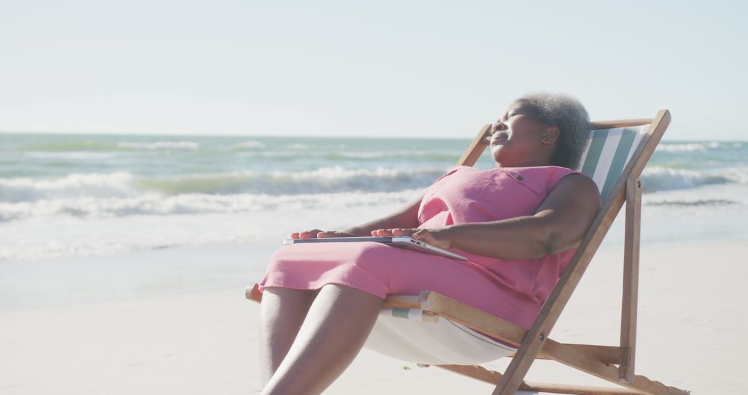 Senior Woman Relaxing On Tropical Beach In Pink Dress - Free Images, Stock Photos and Pictures on Pikwizard.com