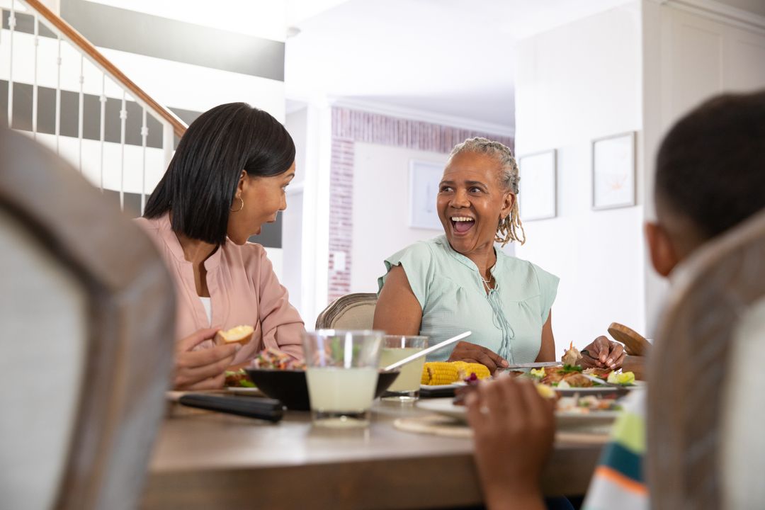 Diverse Family Joyfully Sharing Meal at Home Dining Table