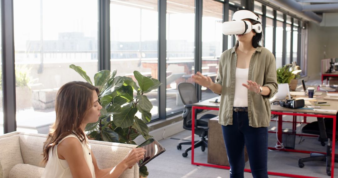 Coworkers Engaging with Tablet and VR in Modern Office Environment