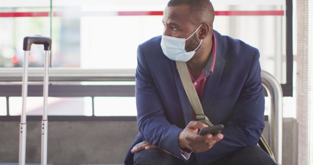 Man with Mask Waiting at Bus Stop During Pandemic