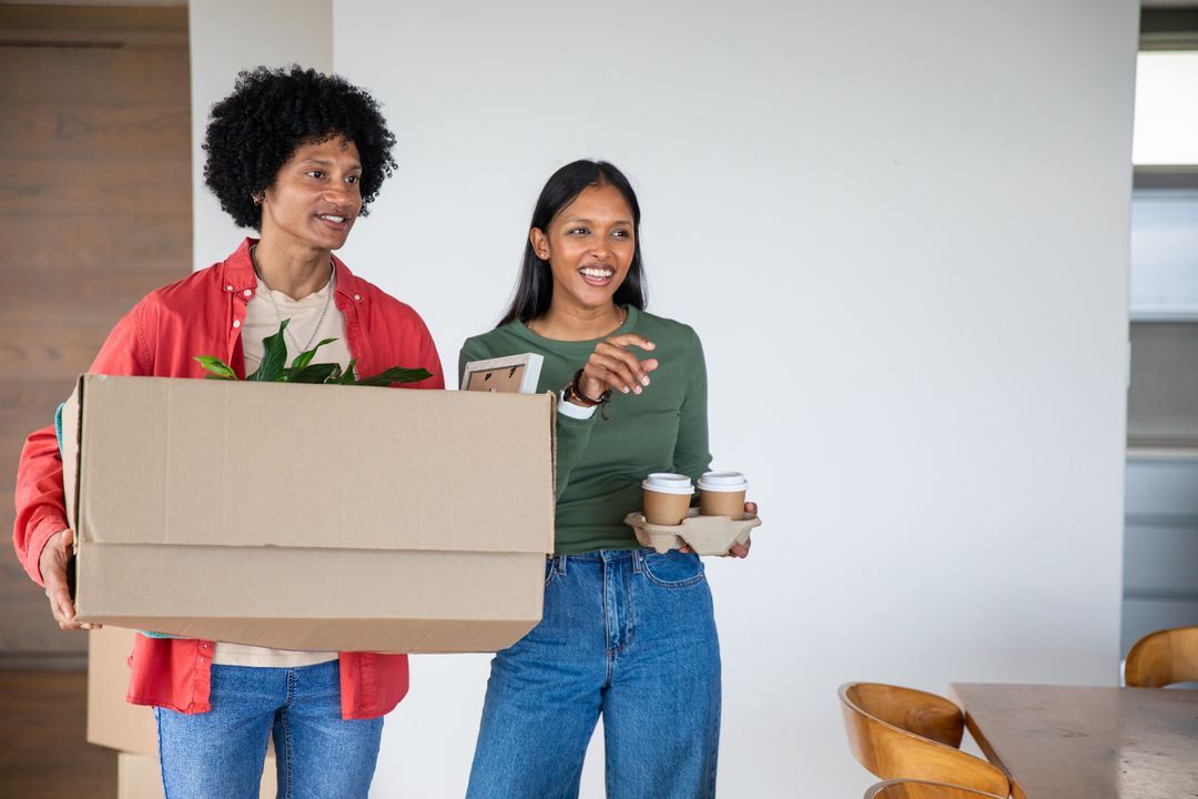 Excited Couple Moving Into New Home With Boxes and Coffee