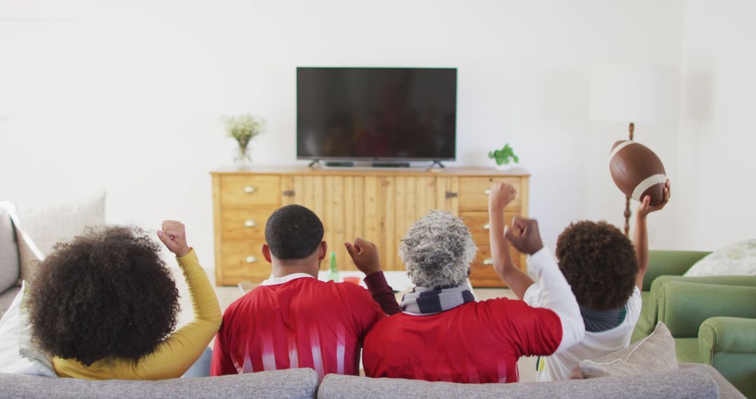 Family Enjoying Football Game on TV, Celebrating Victory Together - Free Images, Stock Photos and Pictures on Pikwizard.com