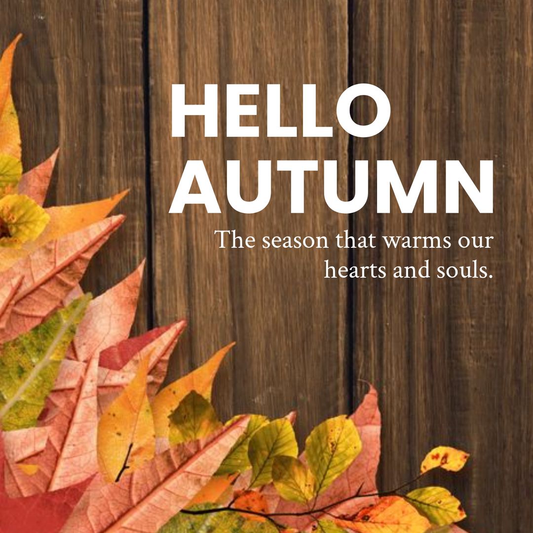 Hello Autumn Text with Warm Colors and Leaves on Wooden Background