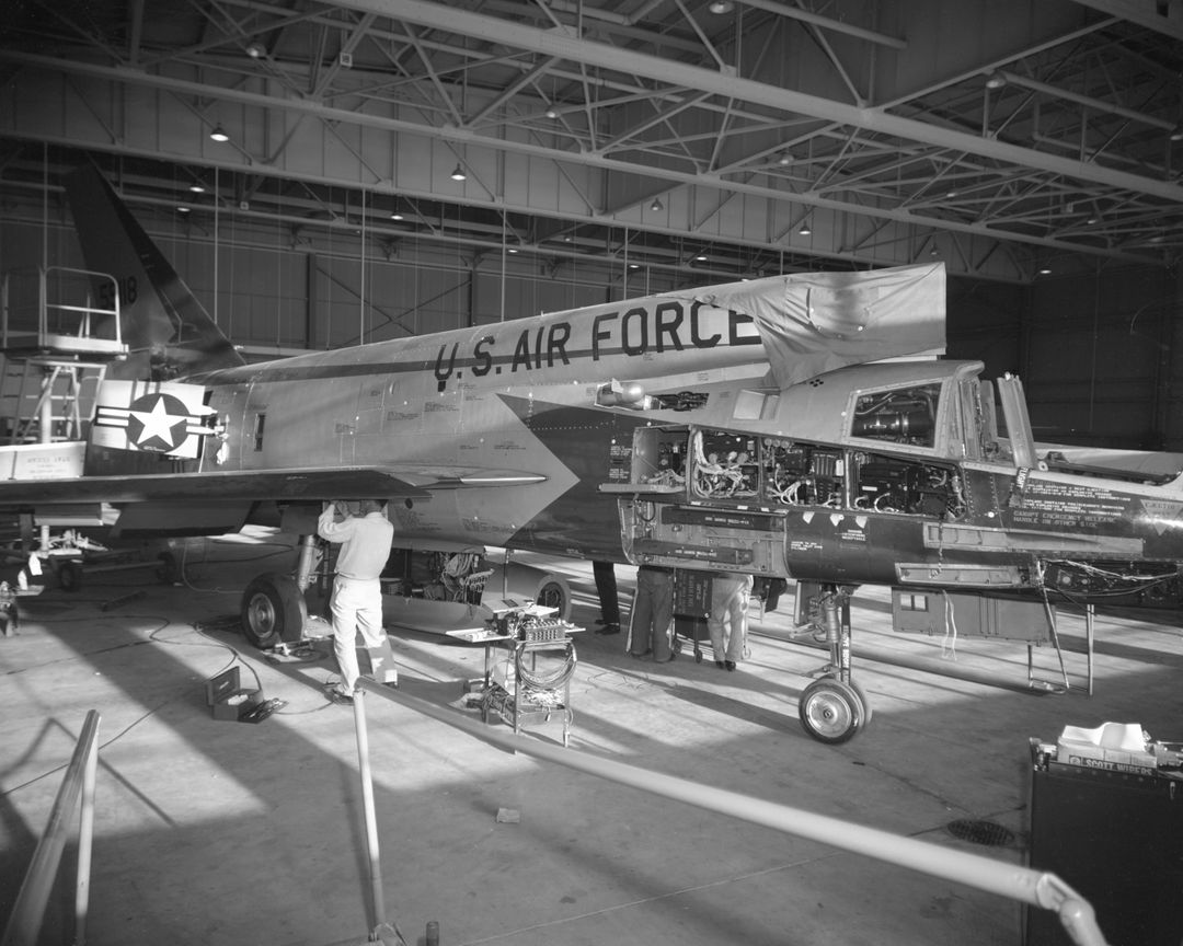 Maintenance Work on F-107A Aircraft in Hangar with Crew Members, April 1958 - Free Images, Stock Photos and Pictures on Pikwizard.com