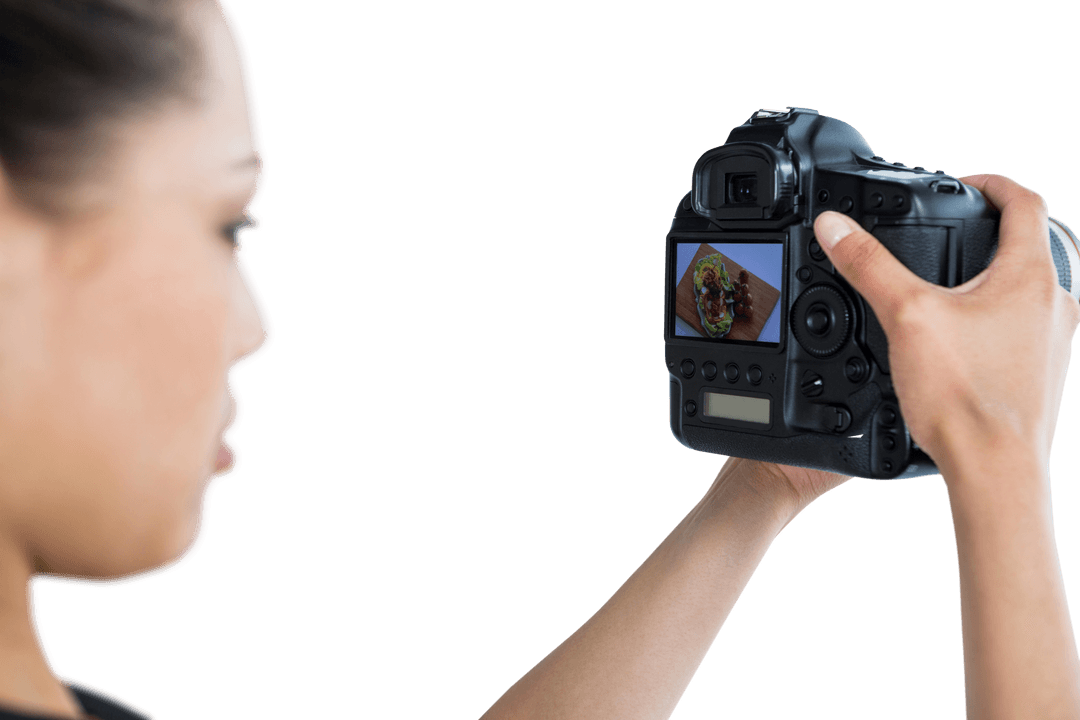 Photographer Reviewing Shot on Camera Display with Transparent Background