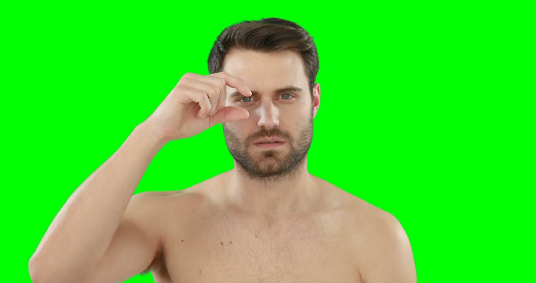 Man Without Shirt Holding Eye Dropper Against Green Screen - Free Images, Stock Photos and Pictures on Pikwizard.com