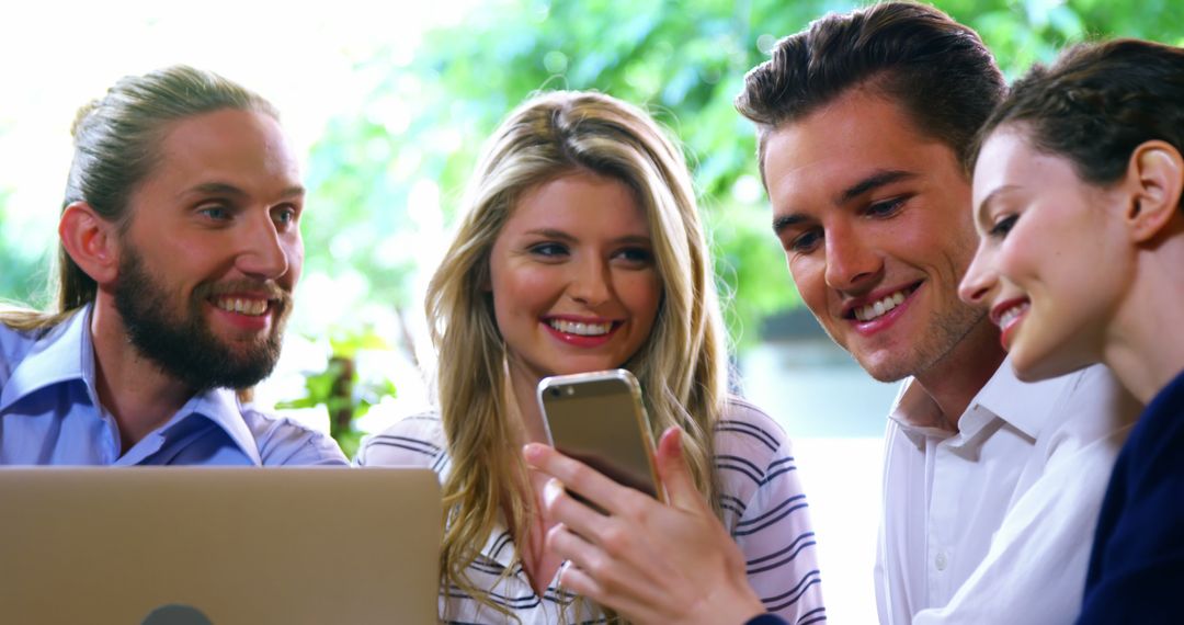 Group of Friends Enjoying Technology and Friendship at Cafe