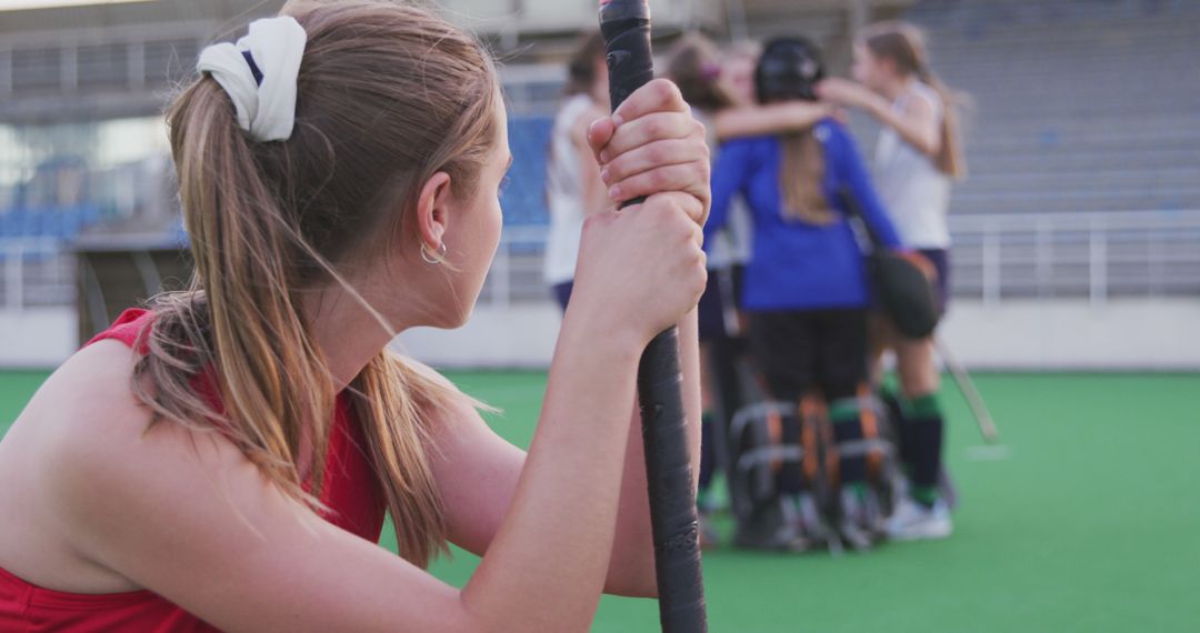 Field Hockey Player Watching Teammates Celebrating Victory - Free Images, Stock Photos and Pictures on Pikwizard.com