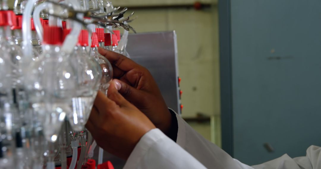 Scientist Adjusting Laboratory Equipment with Precision - Free Images, Stock Photos and Pictures on Pikwizard.com