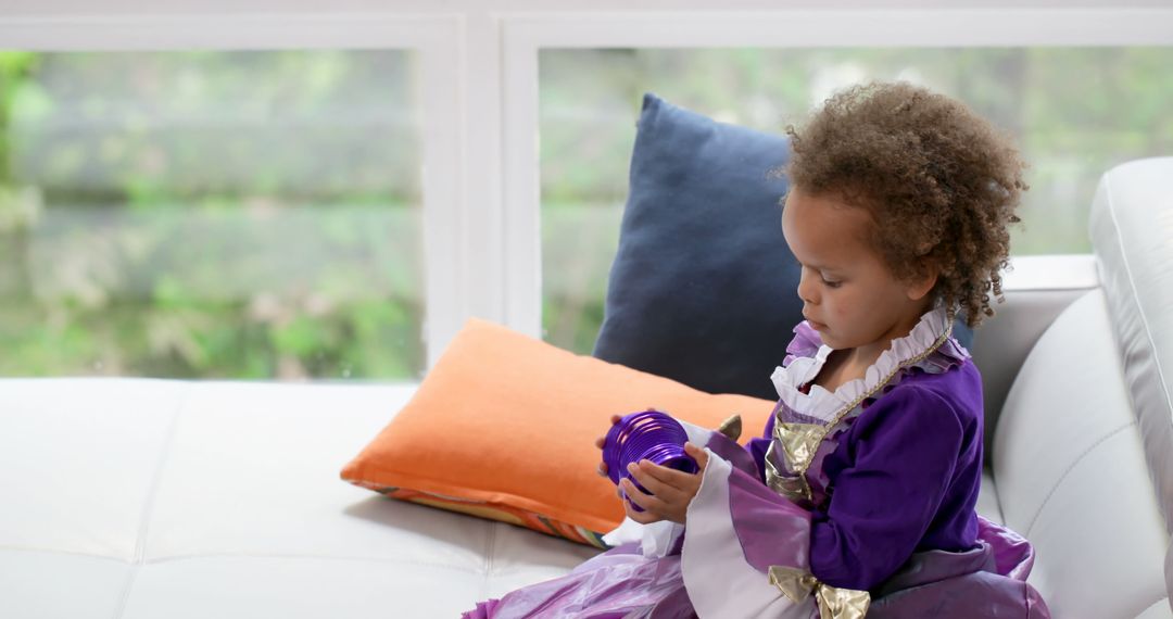 Young Girl Wearing Princess Dress Playing on Sofa - Free Images, Stock Photos and Pictures on Pikwizard.com