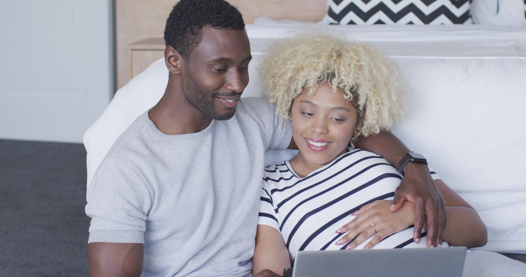 Expectant African American Couple Viewing Ultrasound at Home