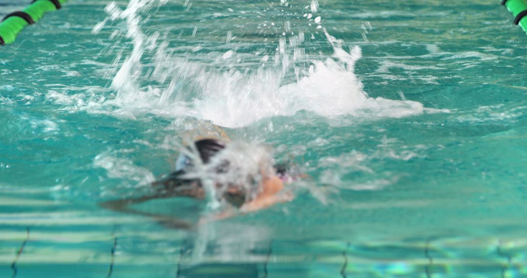 Person Swimming Fast in Indoor Pool Creating Splash - Free Images, Stock Photos and Pictures on Pikwizard.com