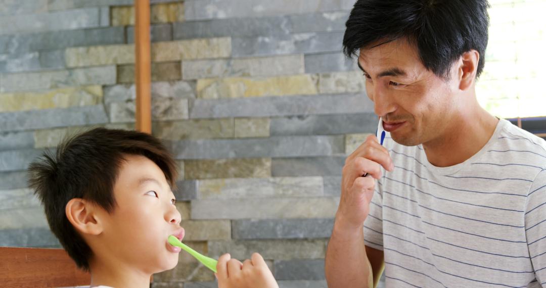 Father and Son Brushing Teeth Together in Bathroom, Daily Hygiene Routine - Free Images, Stock Photos and Pictures on Pikwizard.com