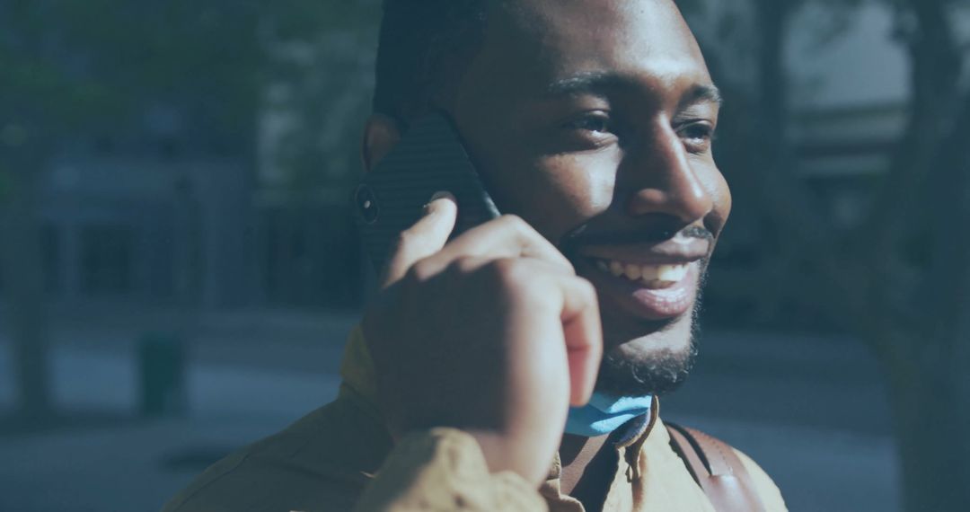 Smiling Man Talking on Smartphone Walking Downside with Backpack