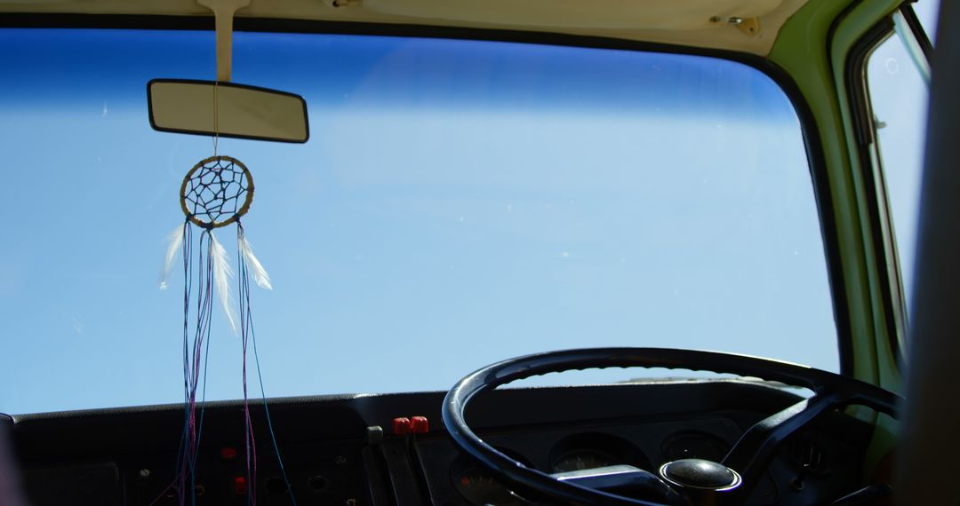 Dreamcatcher Hanging in Vintage Car Interior Against Clear Blue Sky - Free Images, Stock Photos and Pictures on Pikwizard.com