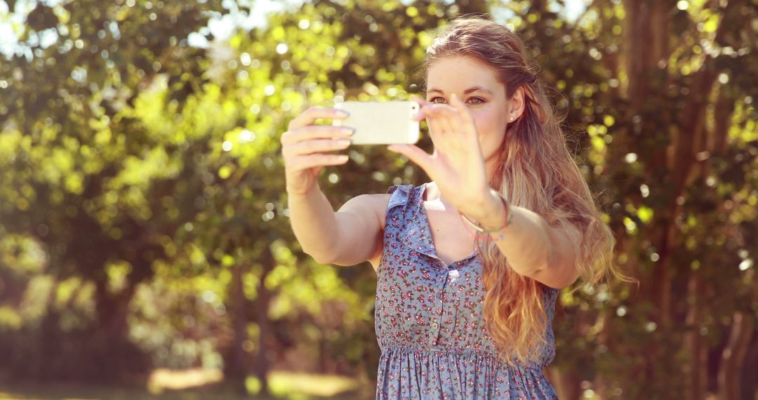 Young Woman Taking Outdoor Selfie on Sunny Day - Free Images, Stock Photos and Pictures on Pikwizard.com