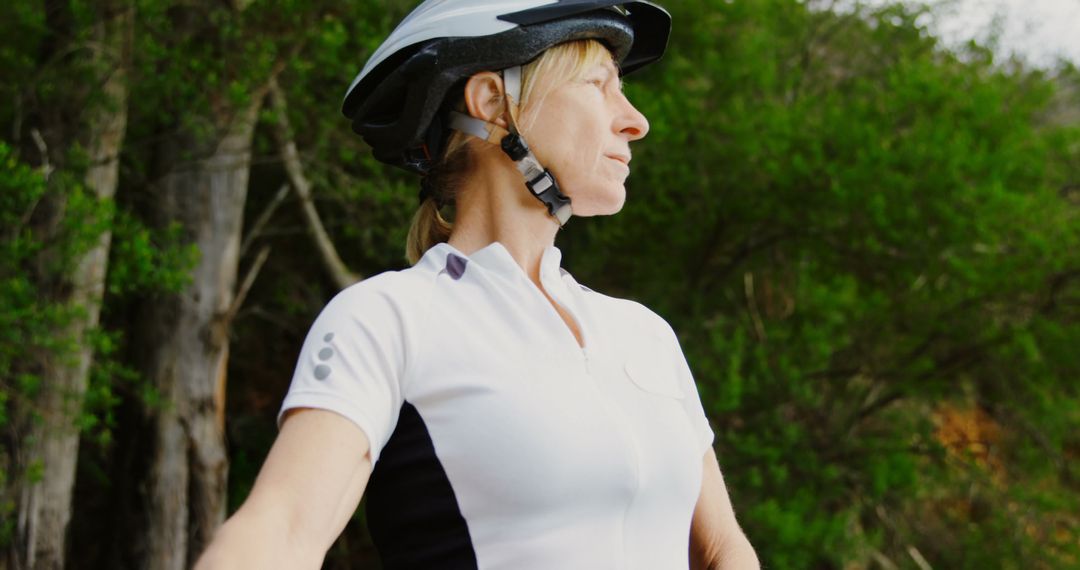 Senior Woman Cyclist Wearing Helmet Posing Outdoors in Nature - Free Images, Stock Photos and Pictures on Pikwizard.com