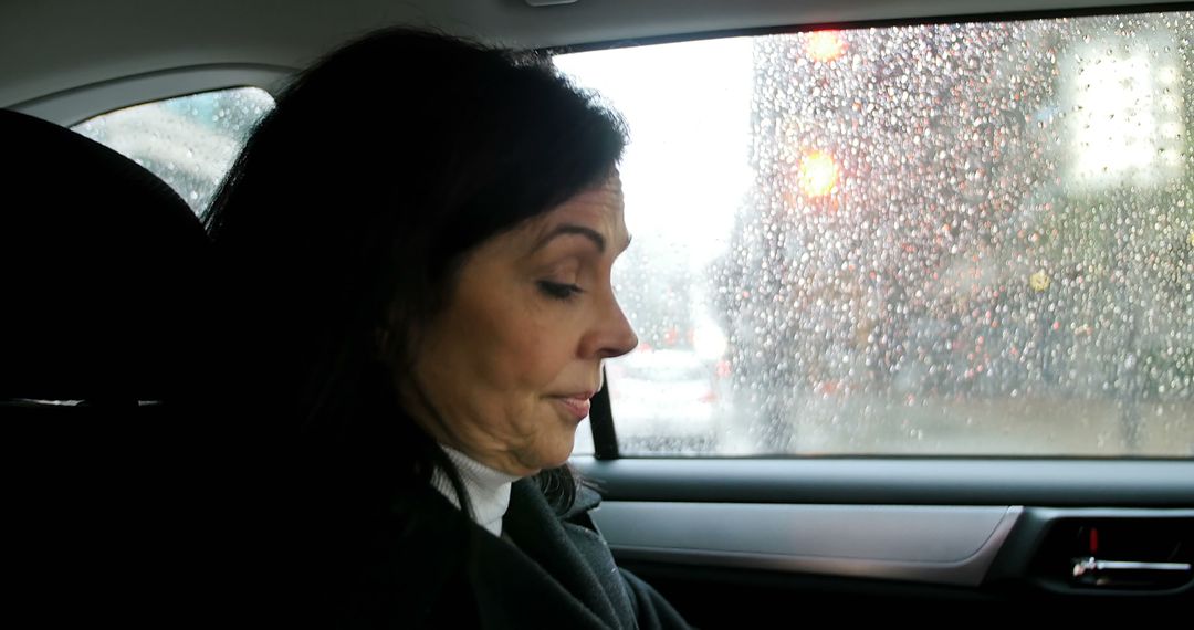 Businesswoman Sitting in Car on Rainy Day - Free Images, Stock Photos and Pictures on Pikwizard.com