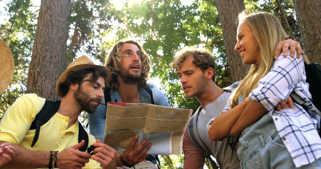 Group of Young Adults Navigating with Map in Forest Adventure