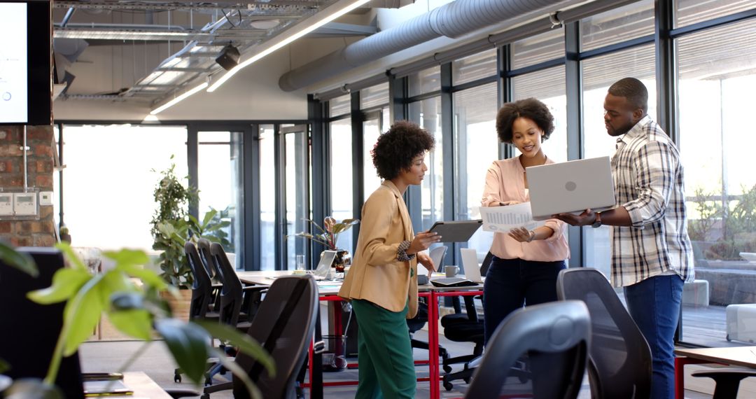 Diverse Business Colleagues Discuss Data in Modern Office