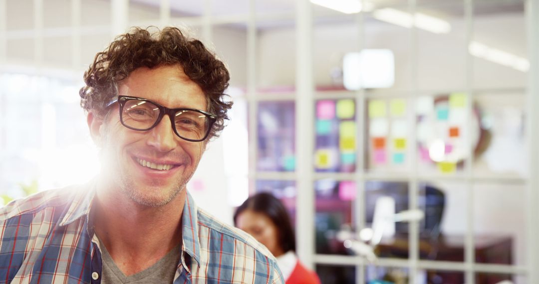 Smiling Man in Glasses with Team in Office Setting - Free Images, Stock Photos and Pictures on Pikwizard.com