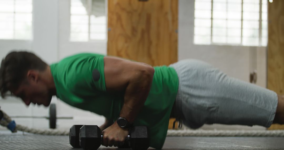 Man Practicing Push-Ups with Dumbbells in Gym - Free Images, Stock Photos and Pictures on Pikwizard.com