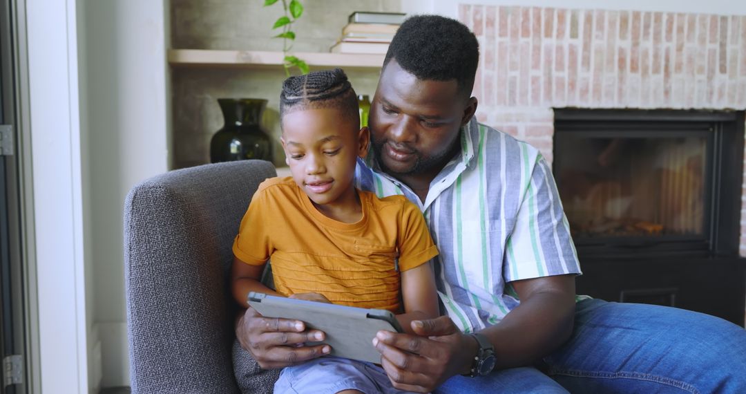 Father and Son Sharing Quality Time Using Tablet at Home