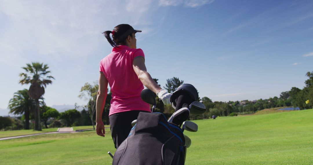 Female Golfer Practicing on Golf Course with Clubs Under Sunny Sky - Free Images, Stock Photos and Pictures on Pikwizard.com