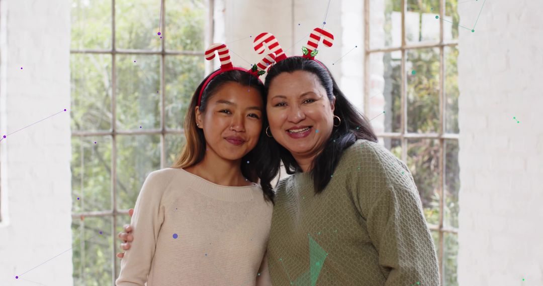 Mother and Daughter Smiling and Posing with Candy Cane Headbands by Multi-Pane Window