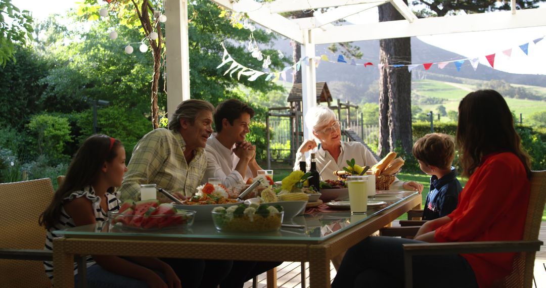 Multi-generational Family Having Dinner in Outdoor Setting - Free Images, Stock Photos and Pictures on Pikwizard.com