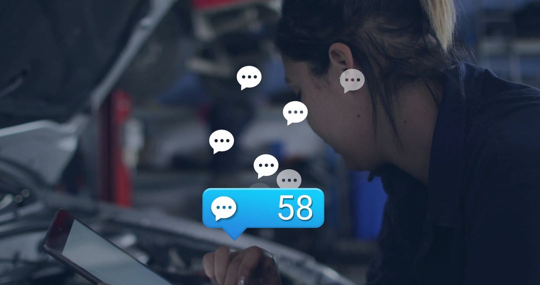 Automotive Technician Using Tablet in Garage with Digital Notifications