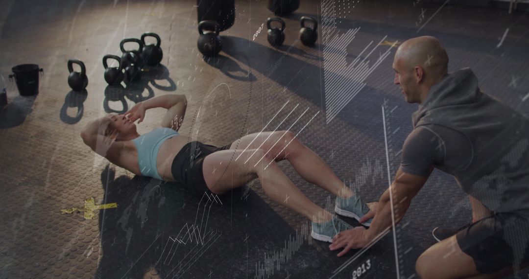 Woman Performing Sit-Ups in Gym with Trainer's Support