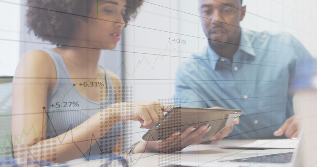 Multicultural Team Analyzing Data on Digital Tablet in Modern Office