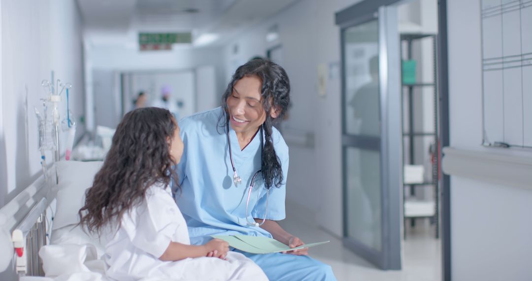 Smiling Nurse Interacting with Young Patient in Hospital Hallway - Free Images, Stock Photos and Pictures on Pikwizard.com