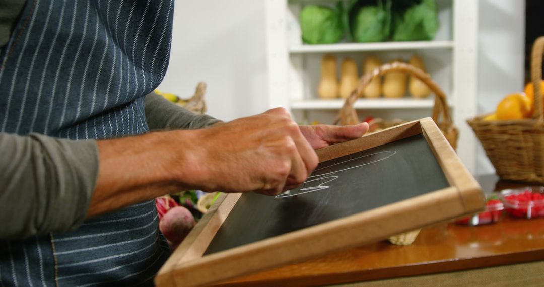 Chef Writing on Chalkboard in Kitchen with Fresh Vegetables - Free Images, Stock Photos and Pictures on Pikwizard.com