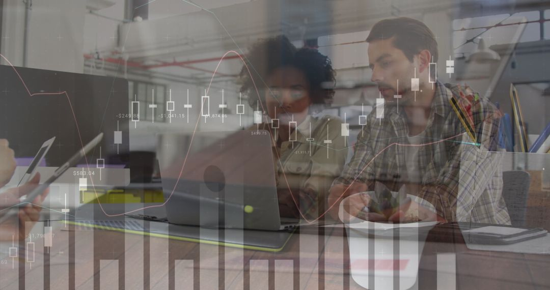 Diverse Team Analyzing Financial Technology in Modern Office