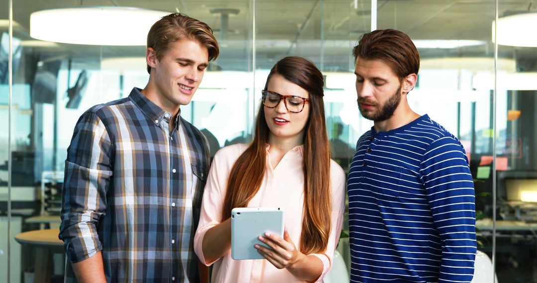 Coworkers Collaborating in Modern Office with Tablet