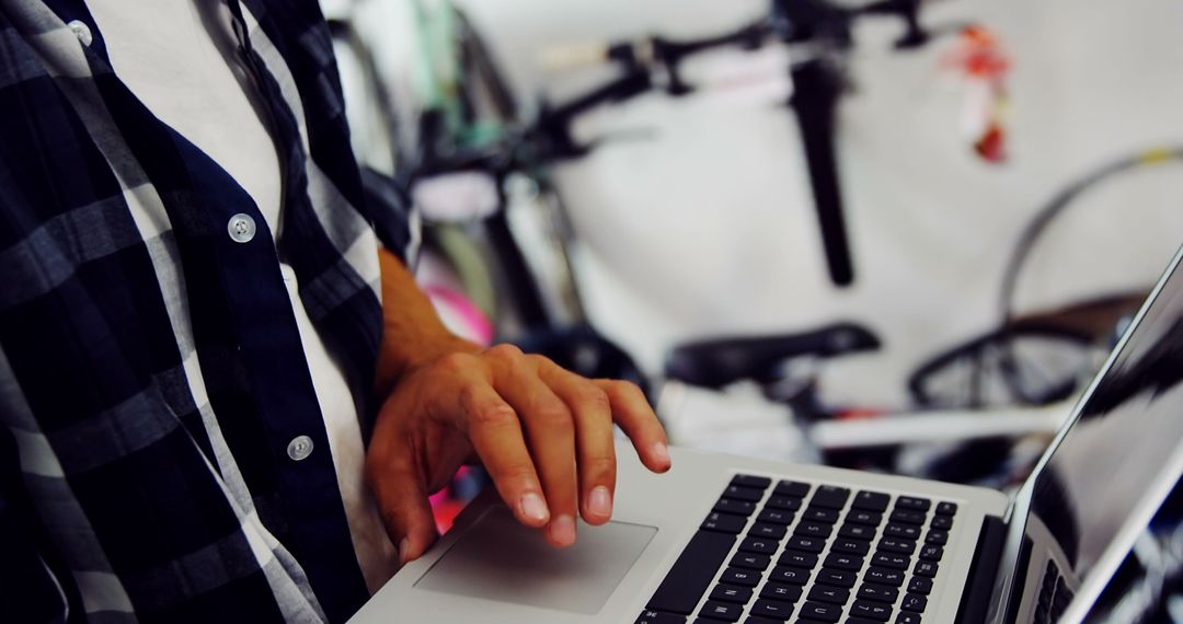 Developer Working on Laptop Near Bikes - Free Images, Stock Photos and Pictures on Pikwizard.com