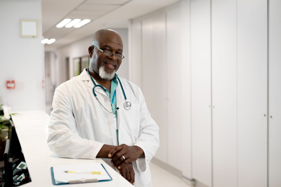 Smiling Senior African American Doctor in Hospital Corridor - Free Images, Stock Photos and Pictures on Pikwizard.com