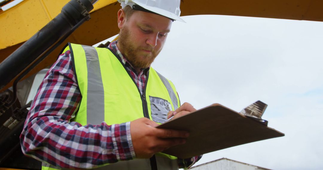 Construction Worker Inspecting Site with Clipboard - Free Images, Stock Photos and Pictures on Pikwizard.com