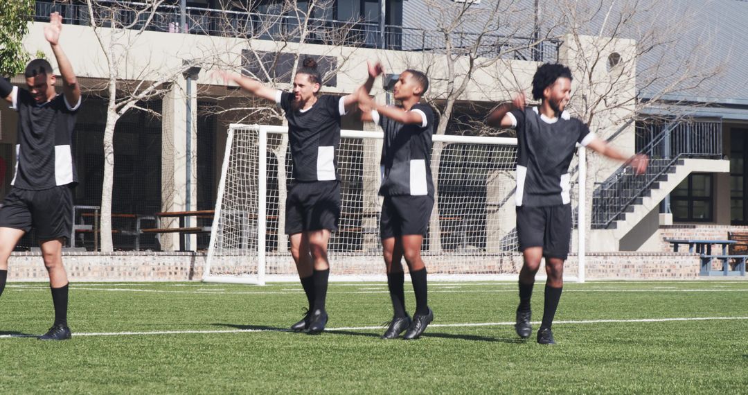 Energetic Soccer Team Warming Up with Dynamic Exercises Outdoors