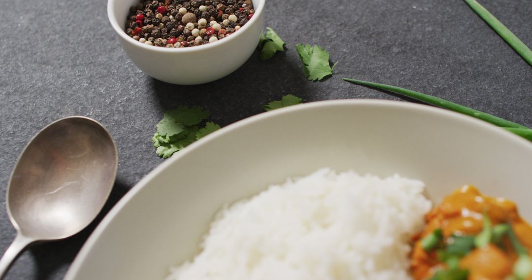 Image of plate with rice and curry lying in grey background - Free Images, Stock Photos and Pictures on Pikwizard.com