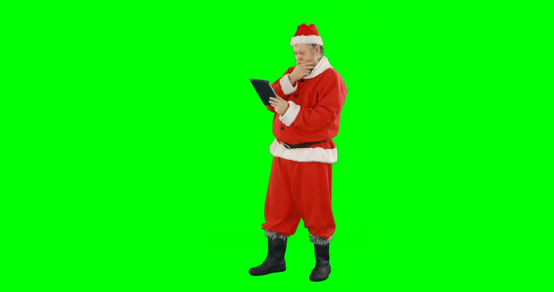 Santa Claus Pondering with Tablet on Green Screen - Free Images, Stock Photos and Pictures on Pikwizard.com